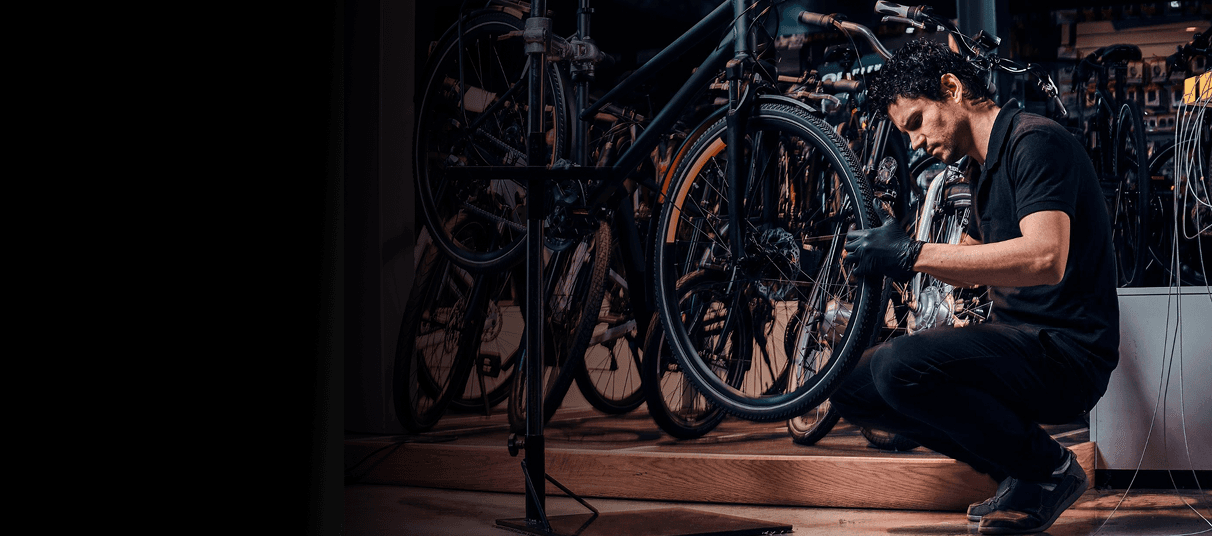 Mechanic working on bicycle in workshop